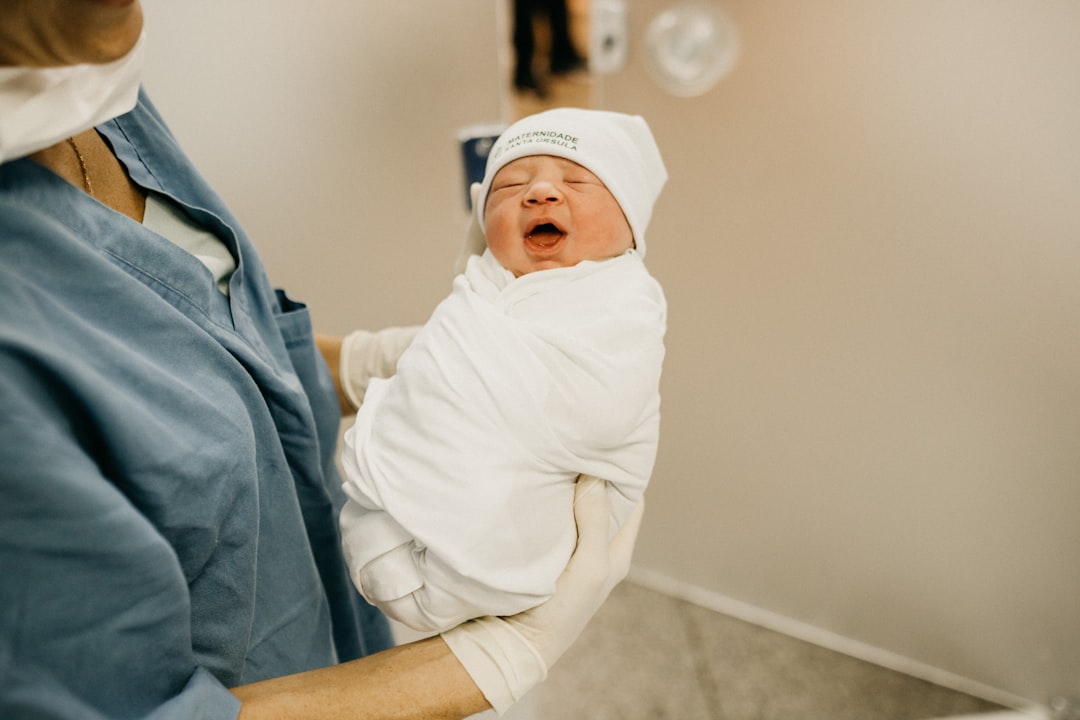 woman-carrying-baby-w-rtffxk9tm
